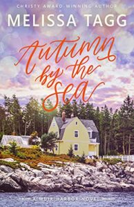 Image of Autumn By the Sea cover. a yellow house sits on a rocky outcrop overlooking the ocean. A forest and purply pink cloudy sky make up the background