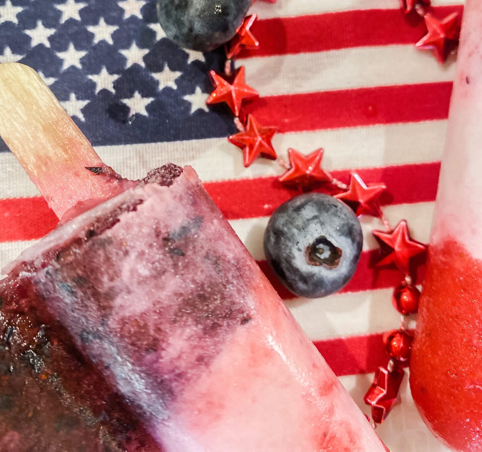 close up of blue and white popsicle and American flag