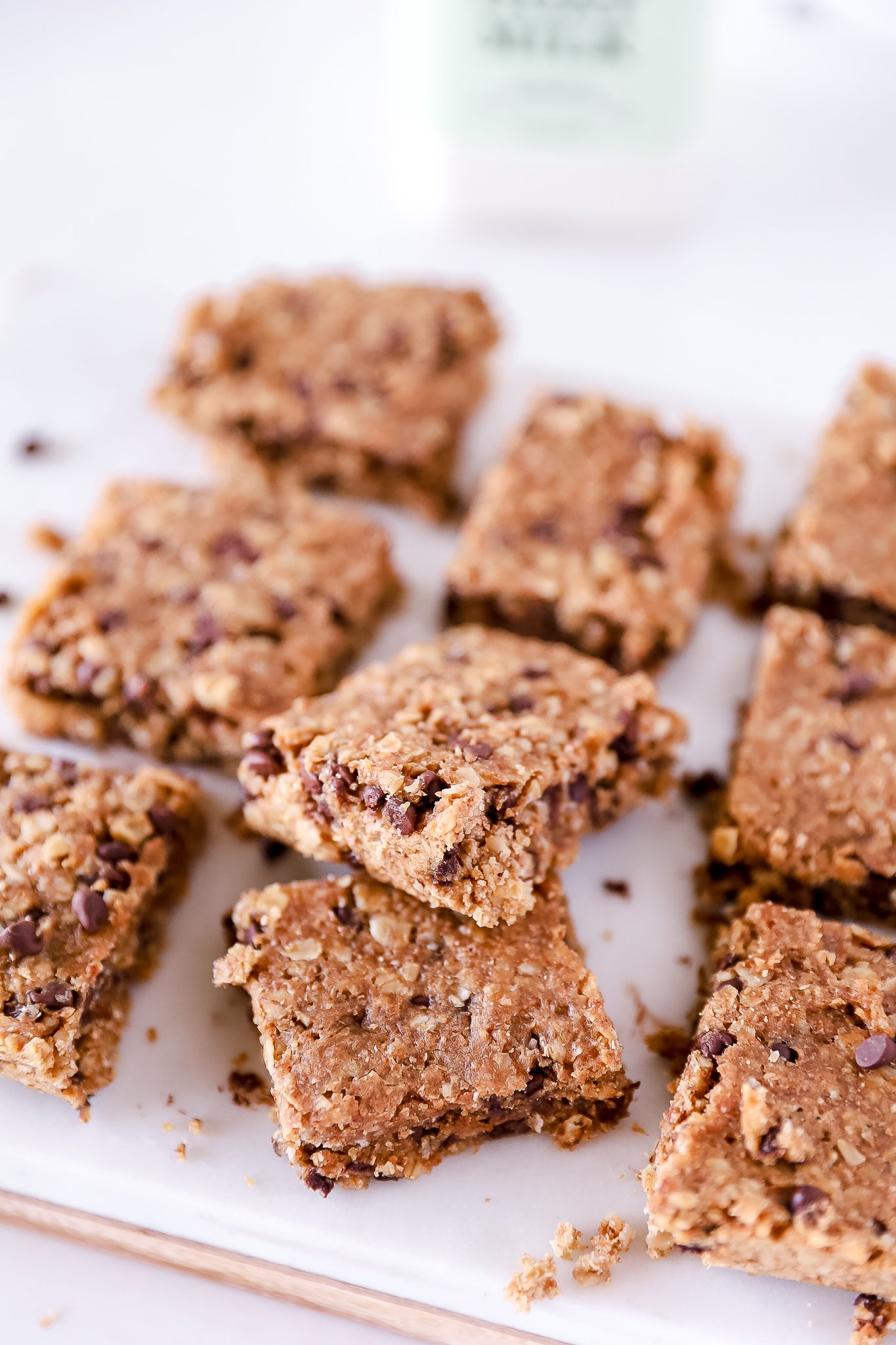 a pile of brown breakfast bars with a corner of a Summerhill Goat Milk bottle in the background